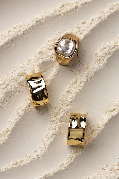 Fotografía de anillo de oro sobre fondo de polvo blanco con IA — Krea